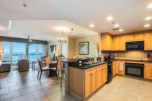 Enjoy cooking in this well-equipped kitchen with a central island, sink, and ample counter space.
