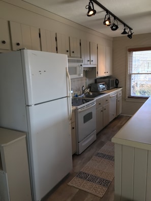 Microwave, dishwasher, coffee/tea maker, cookware/dishes/utensils