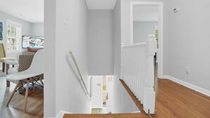 A bright, modern interior with a staircase leading to a second floor. - HEART OF DOWNTOWN (Riverwalk, River View, Walk to Shopping, Dining, and Spirits) (Wilmington)