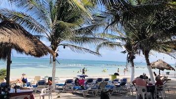 On the beach, white sand, beach umbrellas, beach bar