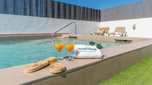 A heated pool, pool loungers