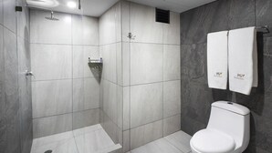 A modern bathroom with a shower, toilet, and towel rack. - Hotel MX lagunilla CDMX, Trademark Collection by Wyndham (Mexico City)