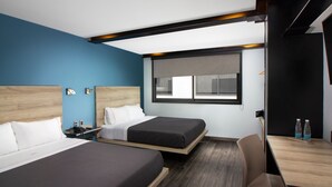 A hotel room with two beds, a desk, and a window. - Hotel MX lagunilla CDMX, Trademark Collection by Wyndham (Mexico City)