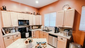 A kitchen with light-colored cabinets, a microwave, a stove, a sink, and a dishwasher. - Welcome to Casa Lana !! (Gold Canyon)