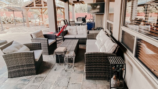 An outdoor patio area with wicker furniture, a ceiling fan, and a TV mounted on the wall. - Welcome to Casa Lana !! (Gold Canyon)