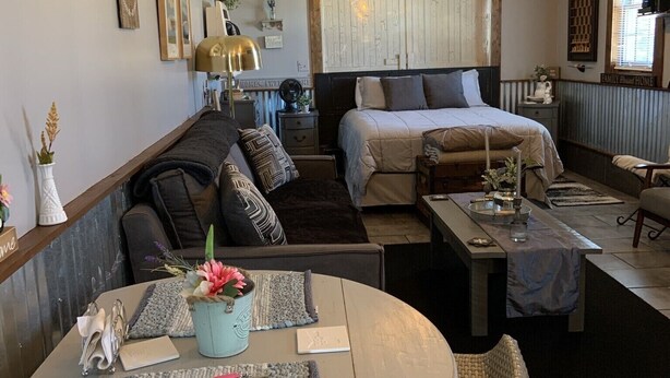 Un salon confortable avec un canapé, une table à manger et un lit.