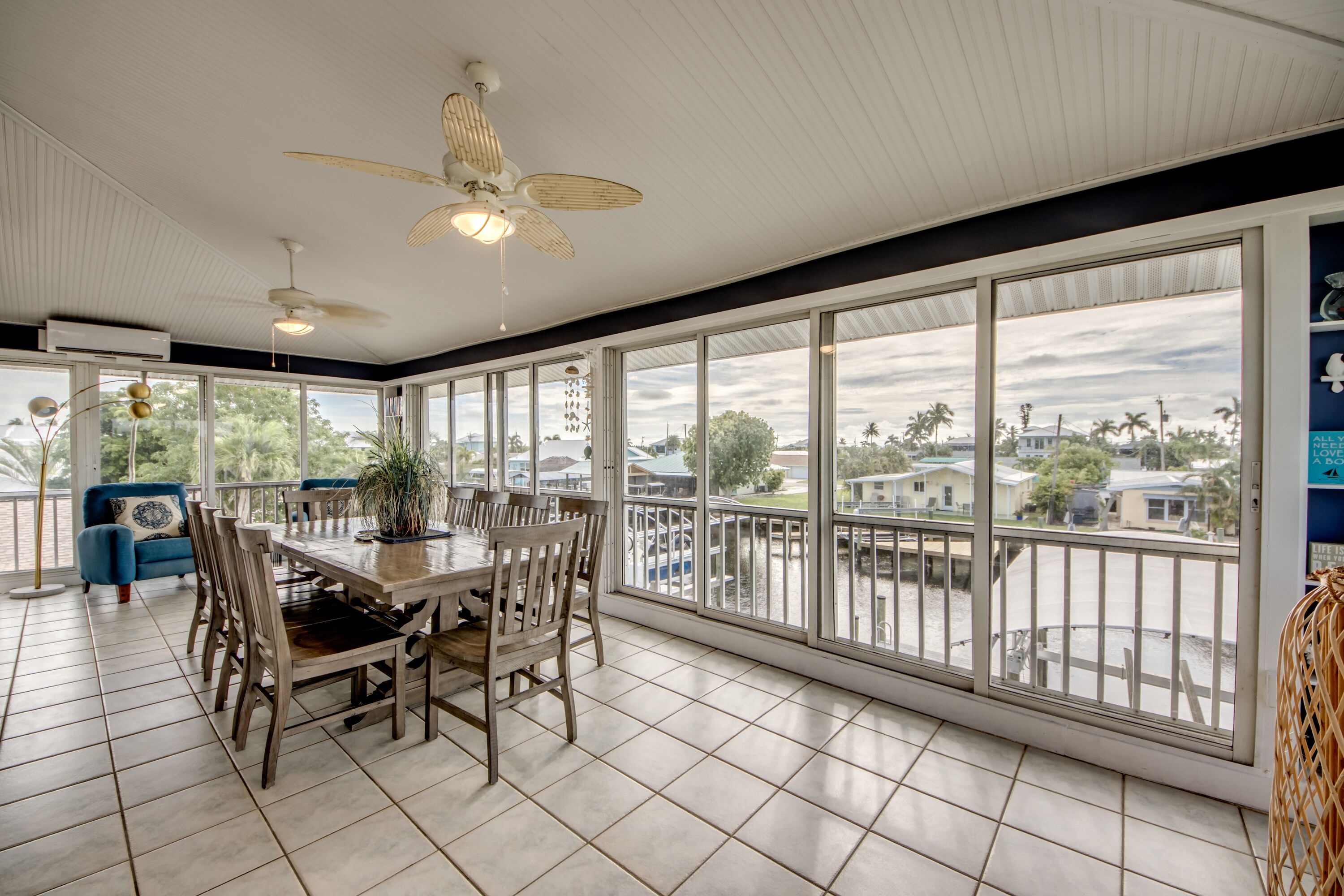 A spacious dining area with a large window overlooking a residential neighborhood.