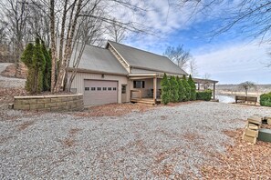 A two-story house with a garage, a covered porch, and a gravel driveway. - Lakefront Retreat w/ Views, Near Mammoth Cave! (Mammoth Cave)