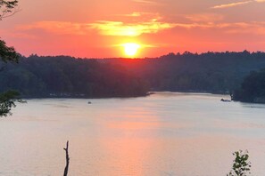 A sunset over a river with a forested hillside in the background. - Lakefront Retreat w/ Views, Near Mammoth Cave! (Mammoth Cave)