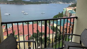 A balcony with a view of a marina and surrounding buildings.