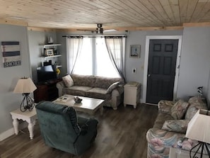 Relax in this inviting living room with a sofa, armchair, and coffee table.