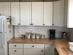 Enjoy cooking in this well-equipped kitchen with an oven, coffee maker, and ample storage.