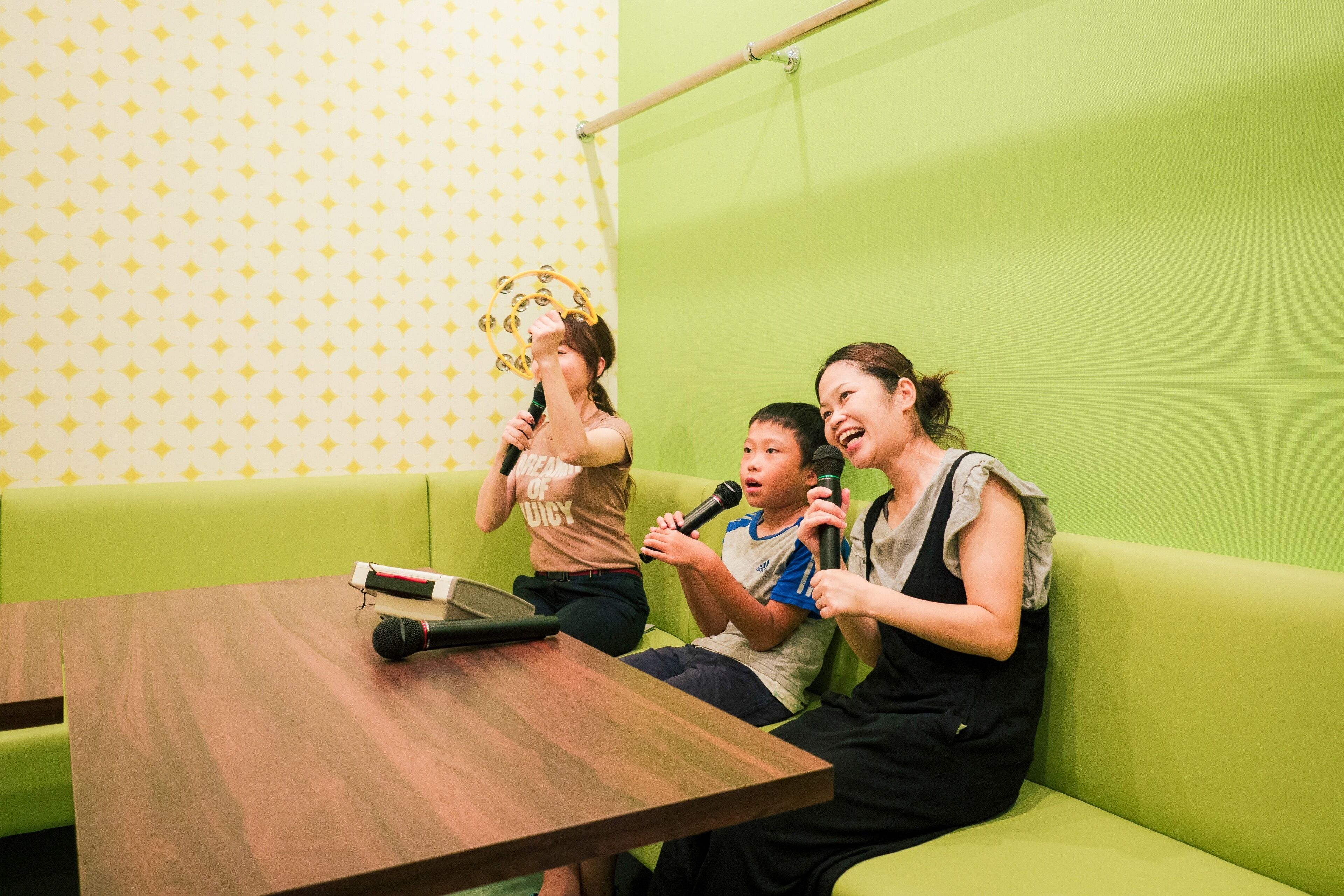 A green couch, a wooden table, and a microphone.