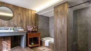A modern bathroom with a wooden vanity, a round mirror, and a shower area. - Zhenchuang Tingyu Pingjiang Inn No.2 (Suzhou)