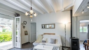 A modern living room with a sofa, a coffee table, and a fireplace. - Pyrénées by Interhome (Capbreton)