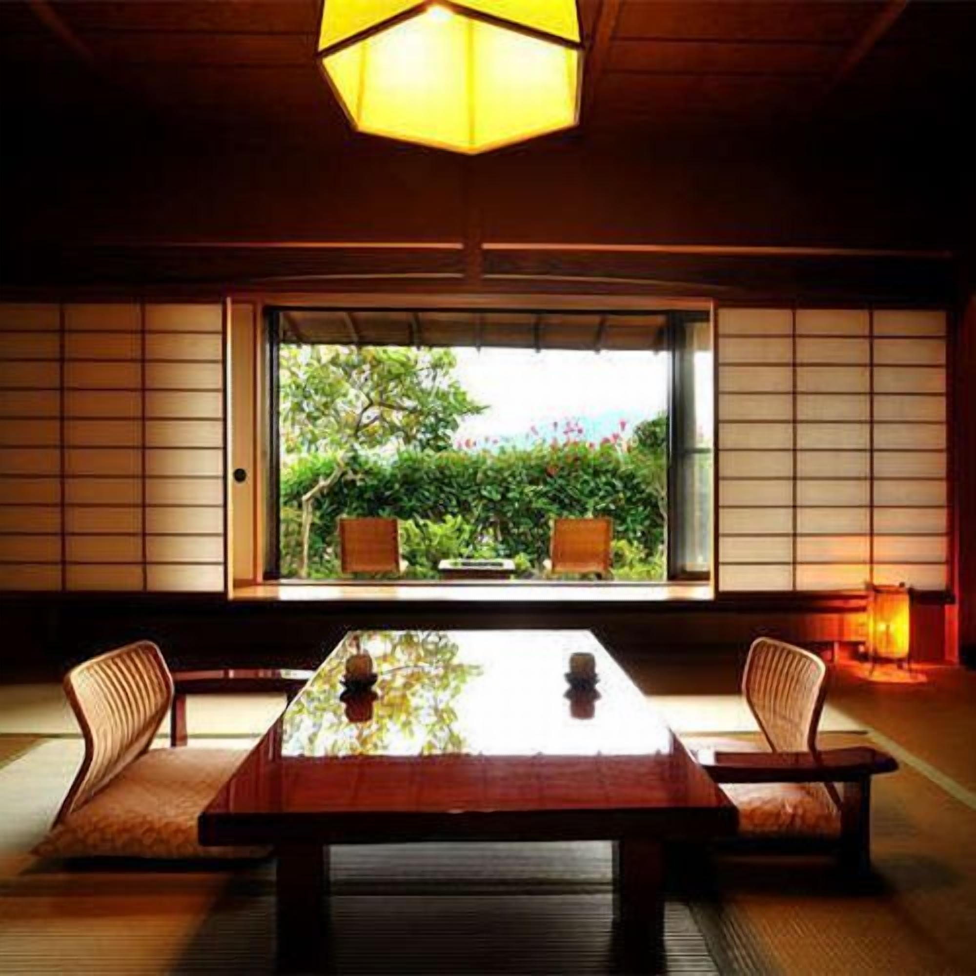 A traditional Japanese room with tatami flooring, a low table, and shoji screens.