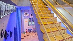 A staircase with yellow handrails leading to an upper floor. - OYO 990 Stadion Residence Syariah (Medan)