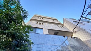 A building with a modern architectural style, featuring a large glass facade and a flat roof.