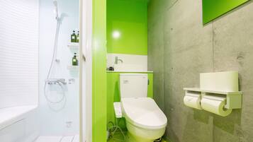 A bathroom with a toilet, a shower, and a toilet paper holder.