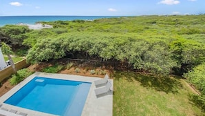 A swimming pool with a view of the ocean and a lush green landscape. - 30A Beachfront and State Park Views, Gulf Trace (Santa Rosa Beach)
