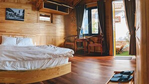 A wooden room with a bed, a desk, and a chair. - Tomorrow Homestay Da Lat (Xuan Huong - Da Lat)