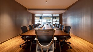A conference room with a long table, chairs, and water bottles. - Xence Hotel (Xiamen)