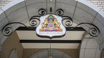 A hotel sign with a crest and the name "Hotel Monterrey Kobe".