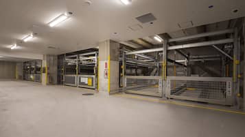 A spacious, modern indoor parking garage with multiple levels and clear signage.