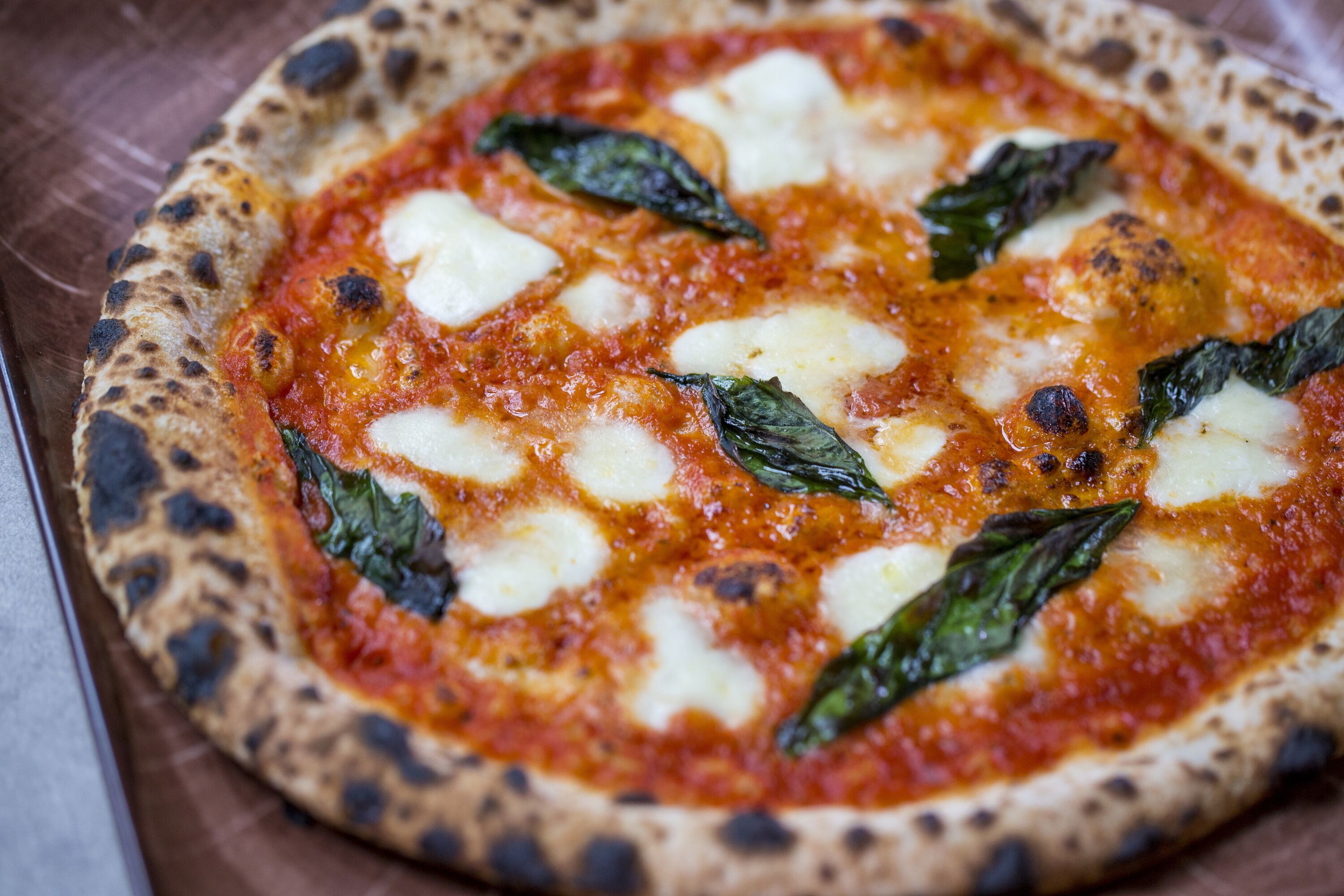 Pizza met kaas en basilicumblaadjes.