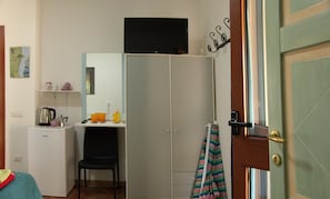 A compact bedroom with a wardrobe, a small desk, and a television. - Residences Gattopardu- "The Little Prince" (Castiadas)