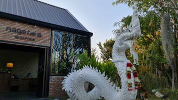 A reception area with a large dragon sculpture outside.
