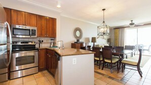 A modern kitchen with stainless steel appliances, wooden cabinets, and a central island. - Hyatt Windward Pointe 2 Bedroom (Key West)
