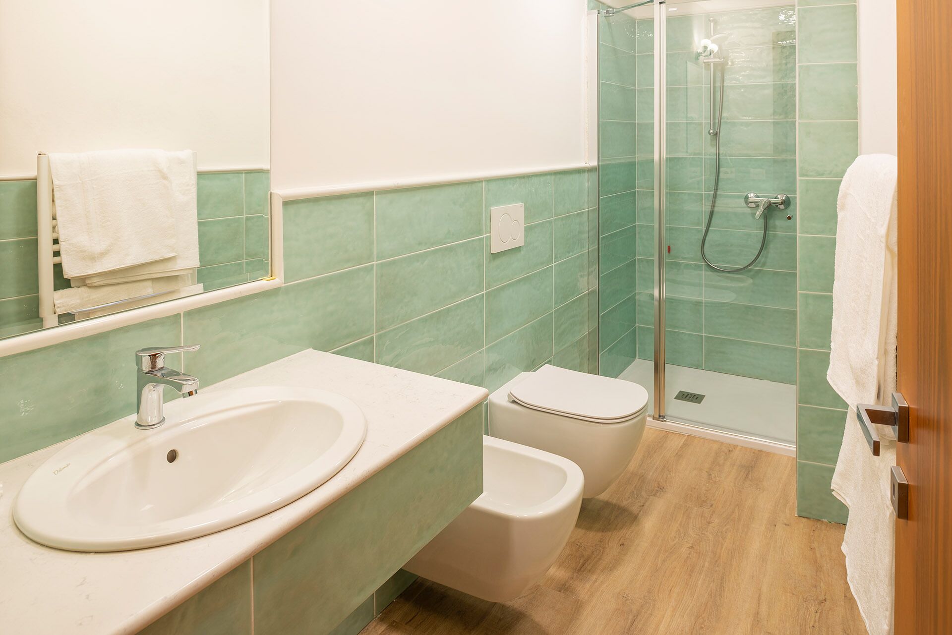 A bathroom with a sink, toilet, and shower.