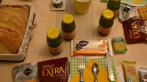 A table set with various food items, including a pie, fruits, condiments, and packaged snacks. - English Inn rooms (Sorrento)