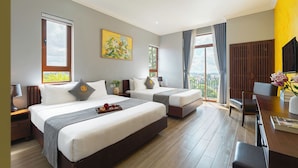 A hotel room with two beds, a desk, a chair, a TV, and a balcony with a view. - Duy Long Hotel (Xuan Huong - Da Lat)