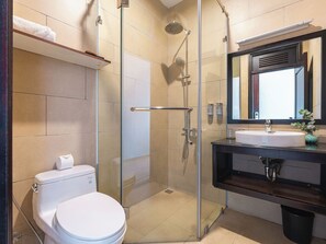 A modern bathroom with a glass-enclosed shower, a white toilet, a sink with a mirror above it, and a towel rack. - Duy Long Hotel (Xuan Huong - Da Lat)