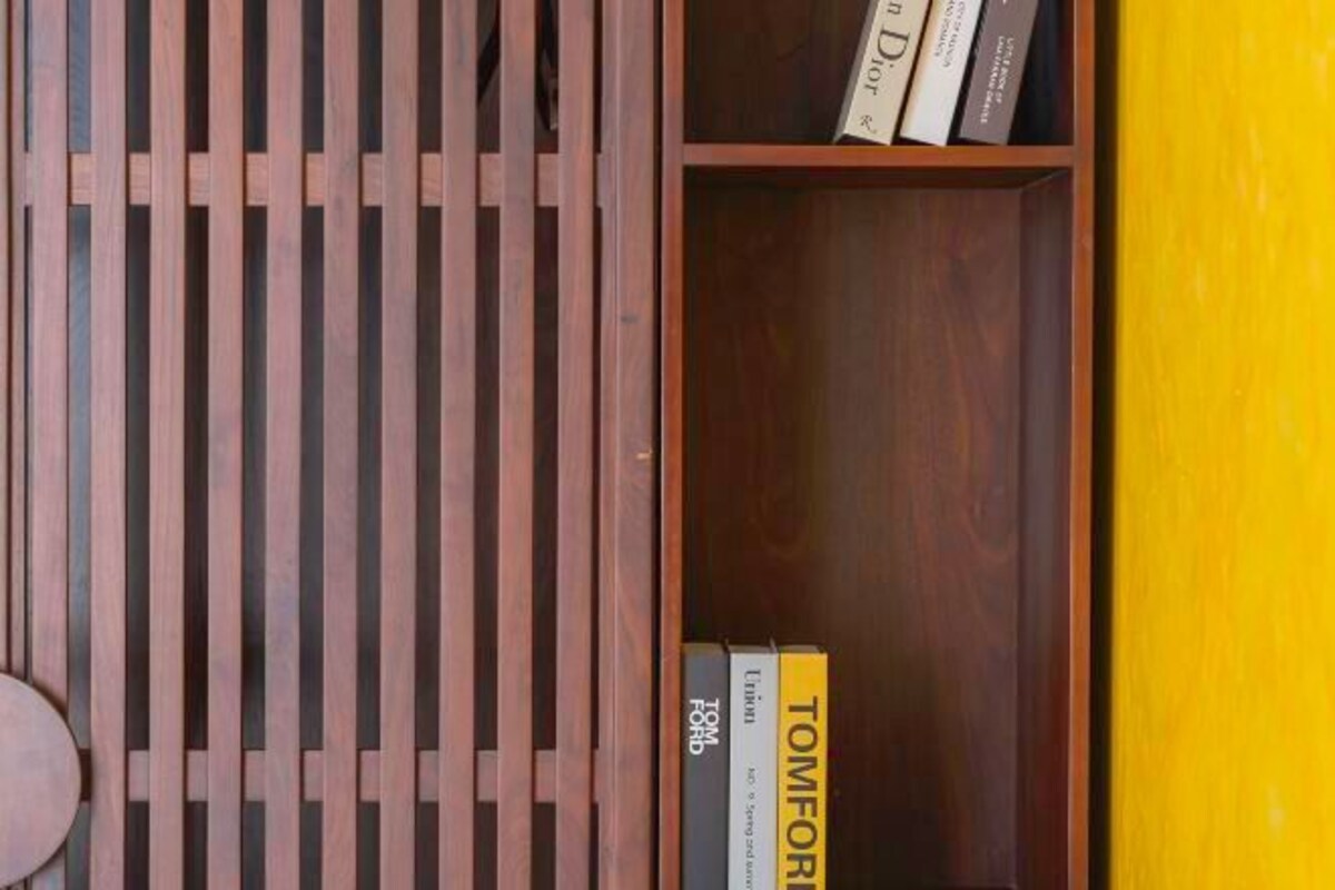 A wooden bookshelf with books, including 'Tom Ford' and 'Union'.
