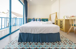 A hotel room with a large bed, a view of the balcony, and a patterned floor. - TURI STAYpoint (Nghia Lo)