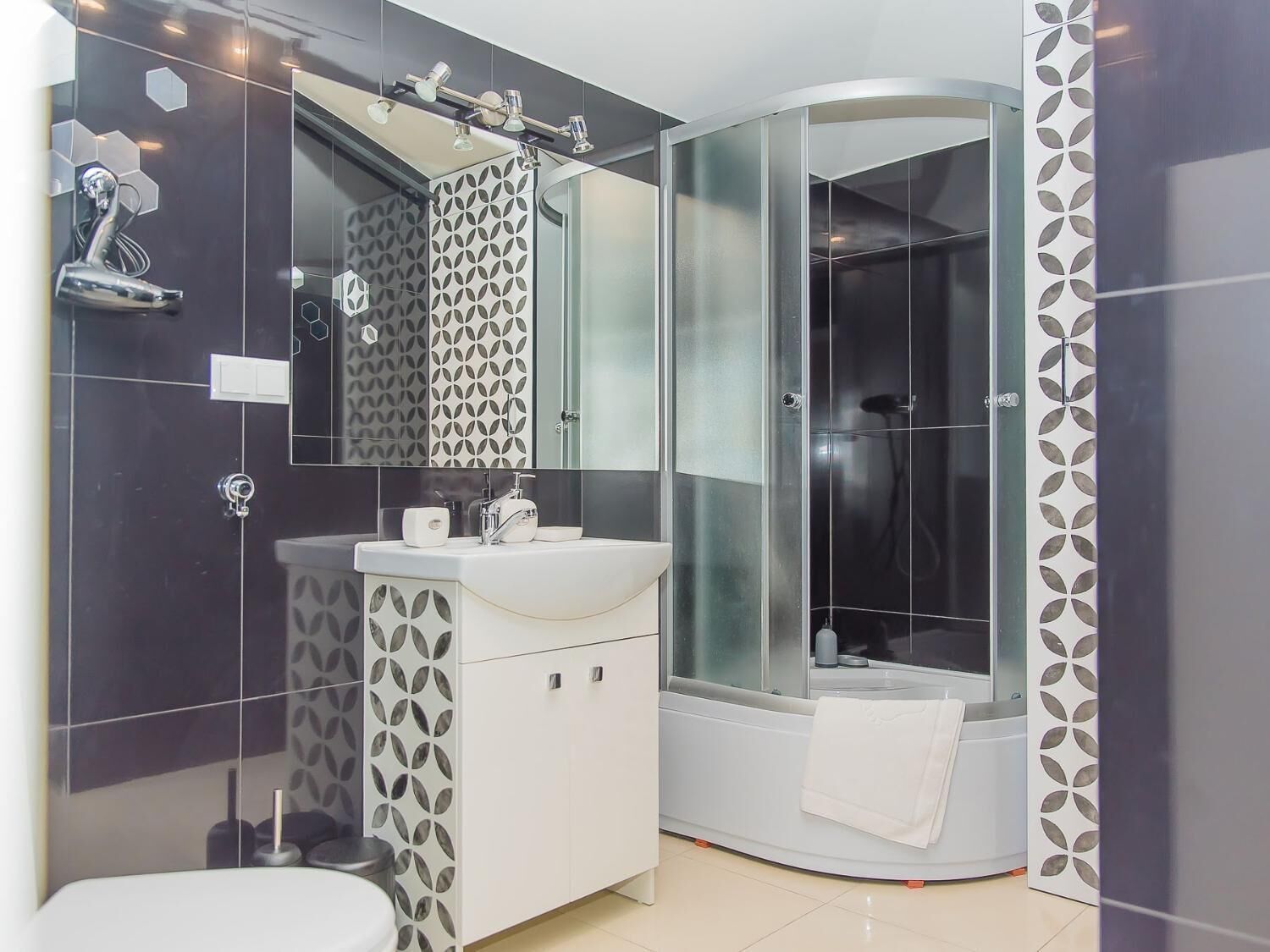 Shower, rainfall showerhead, hair dryer, towels