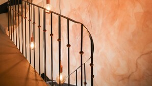 A spiral staircase with hanging light fixtures. - Casa Vinitoscani (Perroy)