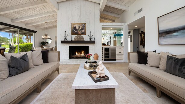A spacious living room with high ceilings, a fireplace, and a view of the outdoors. - LQ001 - 3 bedroom 3 bath with pool (La Quinta)