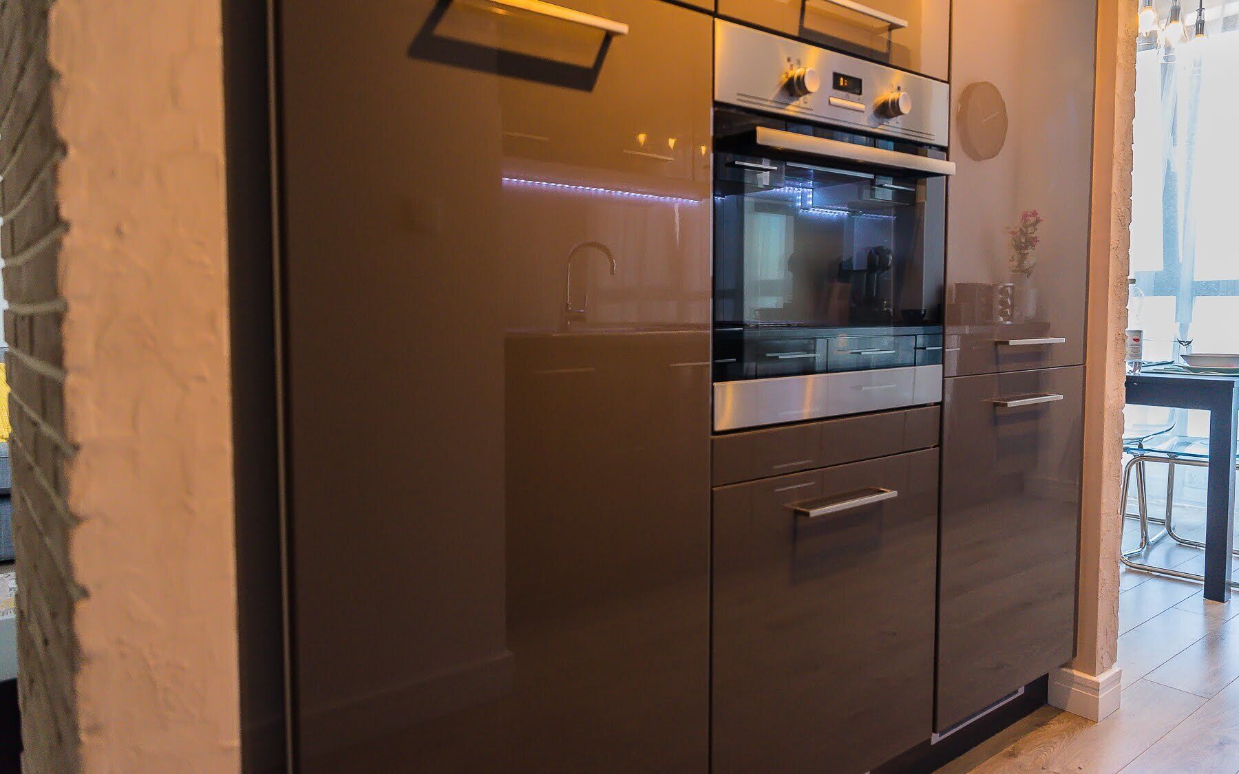 A modern kitchen with stainless steel appliances, a built-in oven, and a microwave.