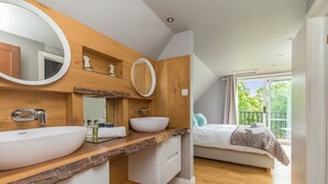 A modern bathroom with a wooden vanity, two sinks, and a large mirror. - Poundgate Park Holiday House 8 Bedroom in 2 adjoining properties ,1h from London (Crowborough)