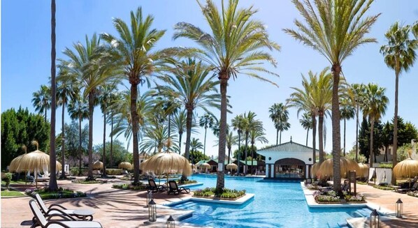 Seasonal outdoor pool, open 11:00 AM to 7:00 PM, pool umbrellas