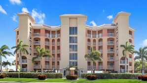 A multi-story hotel with a symmetrical facade, balconies, and a central entrance. - Surf Beach 604 - Spectacular Sunsets - Beach Front (Treasure Island)