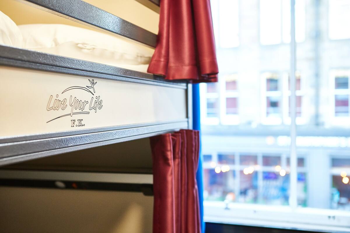 Una cama litera con un logo y texto en la cama inferior.
