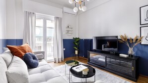 A modern living room with a sofa, coffee table, and TV.