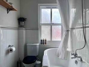 Bathtub, hair dryer, towels, shampoo