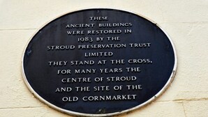A circular plaque with historical information about ancient buildings restored in 1983 by the Stroud Preservation Trust Limited. - Cotswolds Valleys Accommodation-Med Hall (Stroud)
