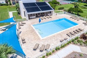 A swimming pool with sun loungers and a covered area with a view of a building with solar panels. - Best Sept Beach Weather! Home + Apt, Pool, Pickleball, Steps to Perfect Water! (Destin)
